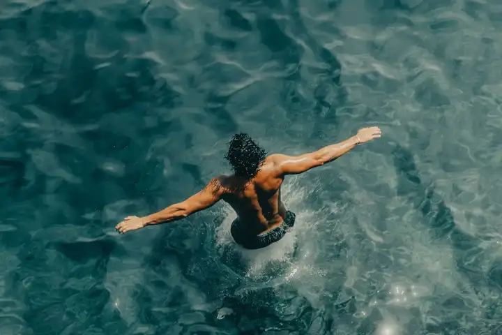 A swimmer floating in clear turquoise water