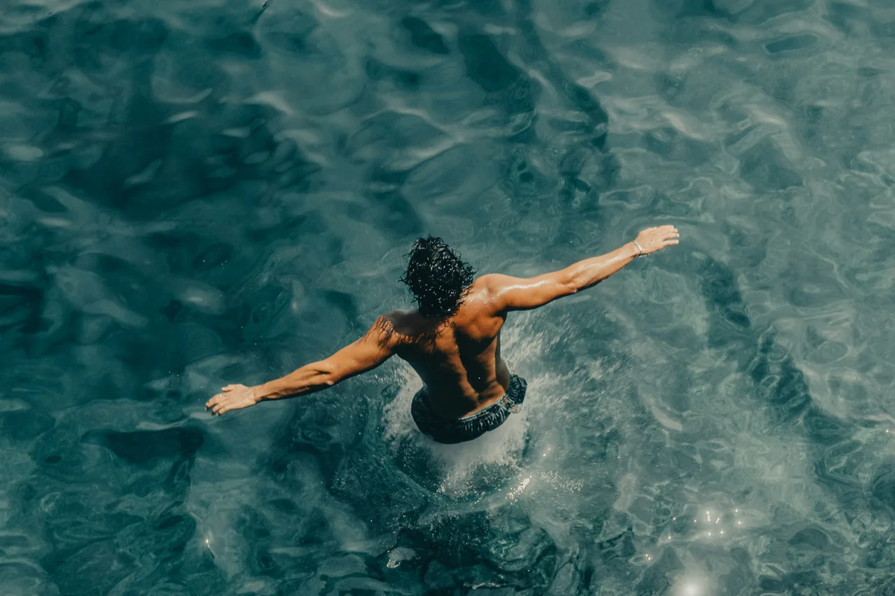 A swimmer floating in clear turquoise water
