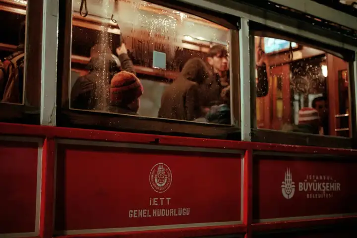 Passengers inside a red tram at night