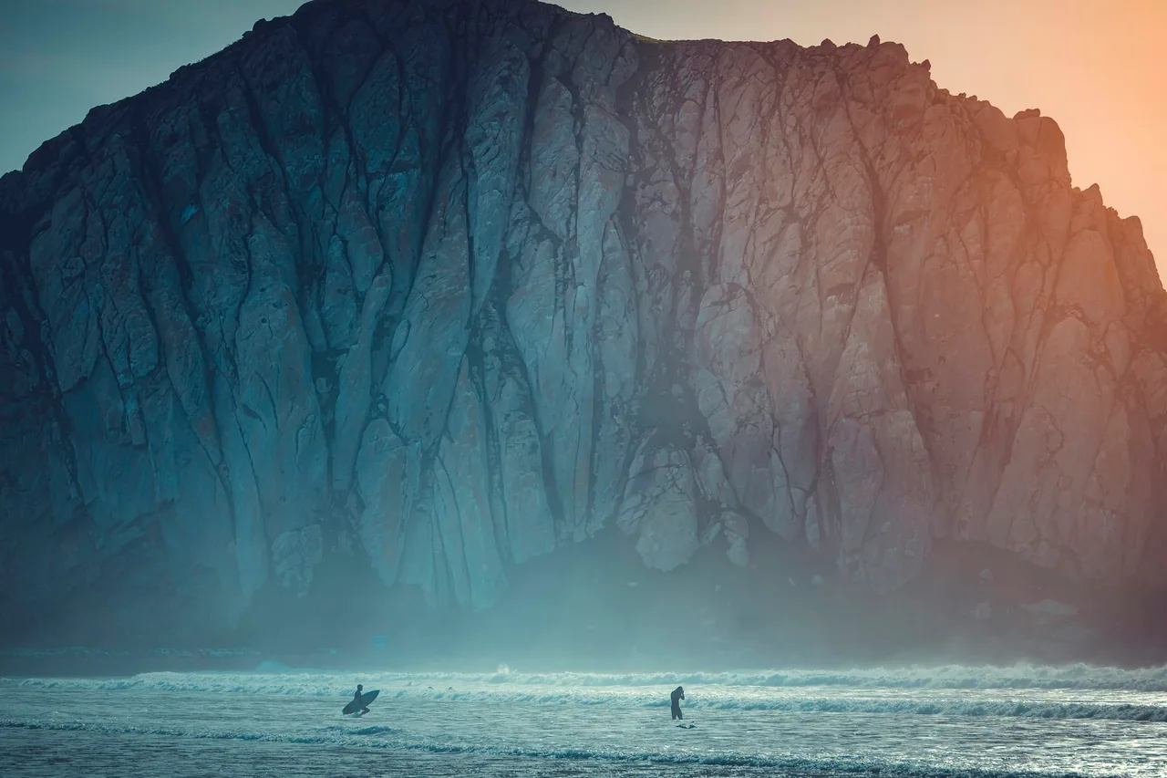 Surfers waiting beneath the cliffs of Morro Rock