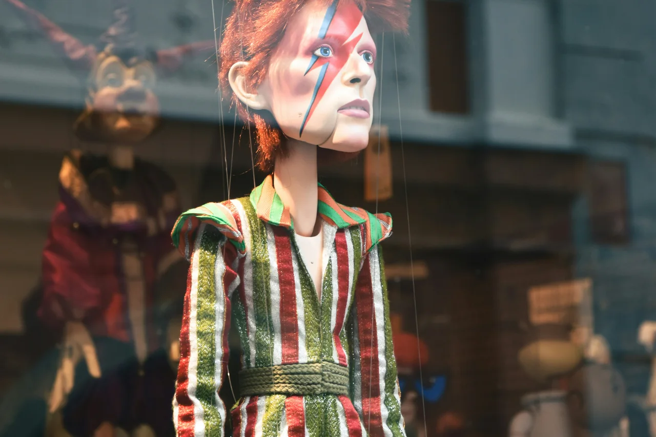 A red-haired woman reflected in a city shop window