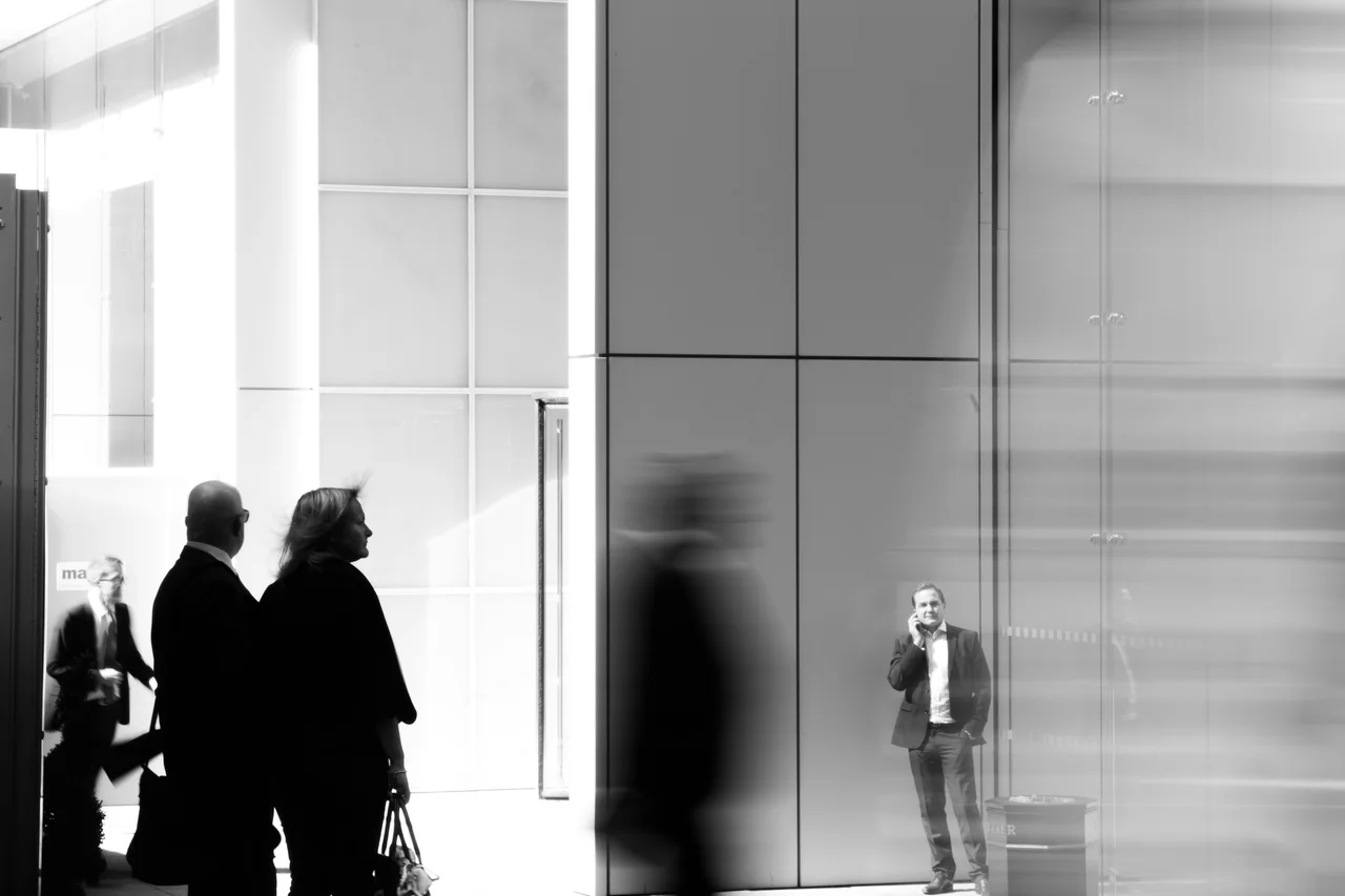 Visitors silhouetted in a bright museum hall