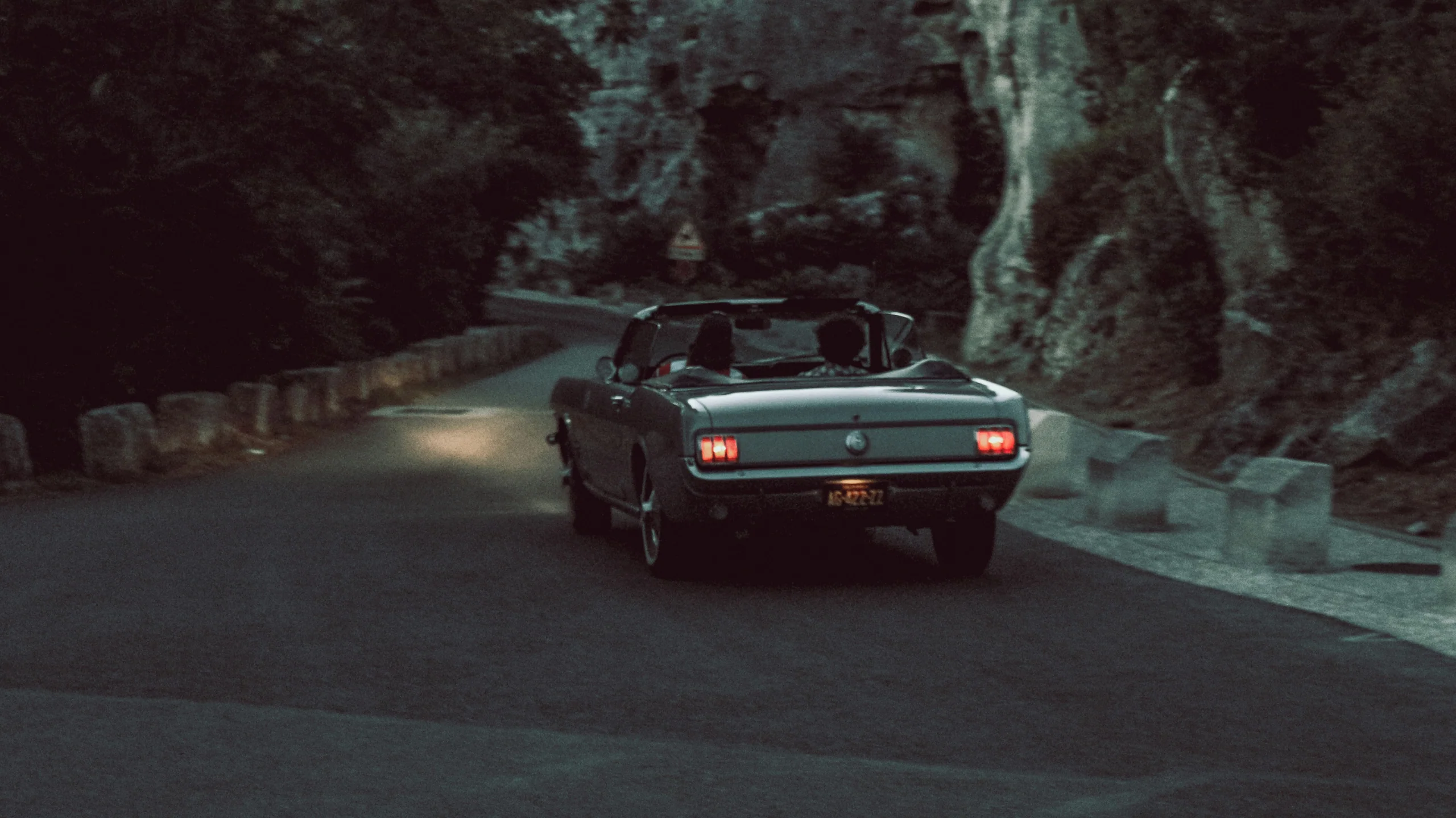 Vintage car on a forest road in blue evening light
