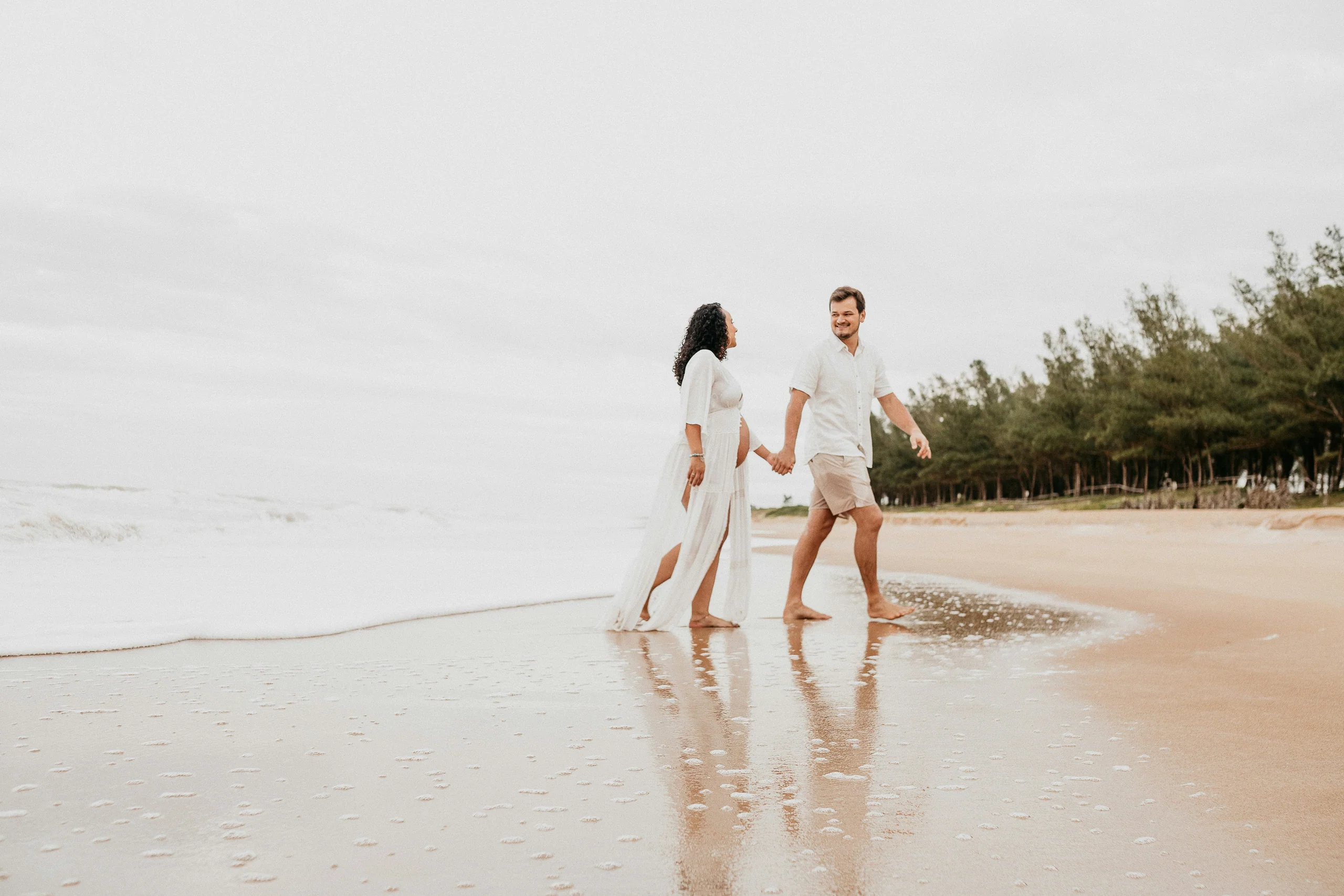 Couple walking hand in hand along the shoreline