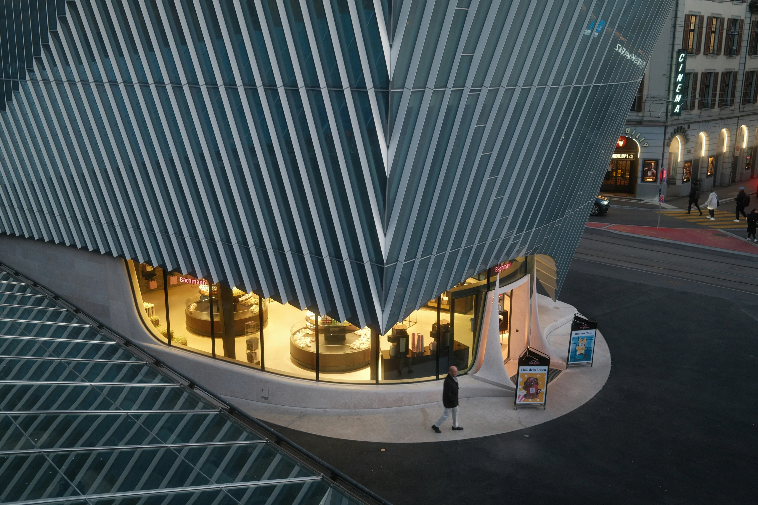White ribbed facade of a modern building at dusk