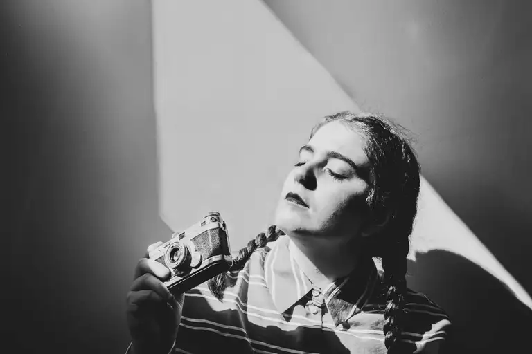 Black and white portrait of a woman lying with her eyes closed